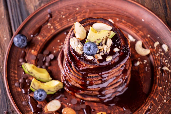 Vegan pancakes based avocado with cocoa and date syrup. Vegan he