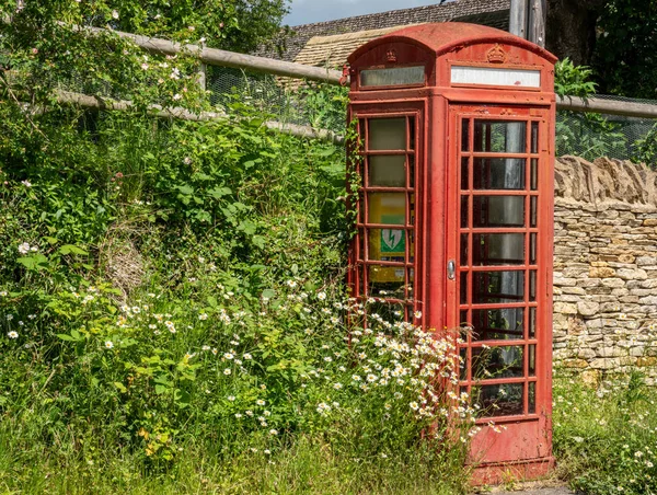 Old traditional British telephone box in Naunton, The Cotswolds, United Kingdom