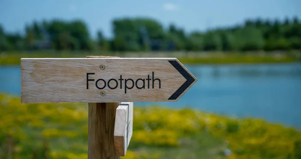 Wooden footpath sign in the Cotswolds, Gloucestershire, England