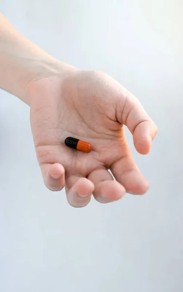 Red Black Pill Form Capsule Lies Outstretched Female Hand — Stock Photo, Image