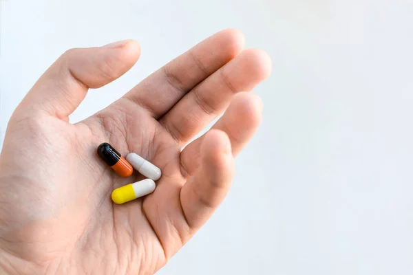 Three Multi Colored Pills Form Capsules Lie Outstretched Male Hand — Stock Photo, Image