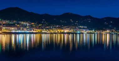 Cefalu sahilinde akşam saatlerinde, ışıklar suyla yansıyor. Sicilya, Güney İtalya.