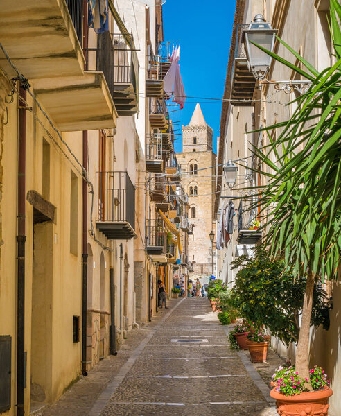 A cozy street in Cefalu, rich with details and colors. Sicily, southern Italy.