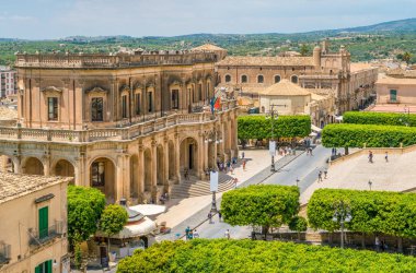 Panoramic view in Noto, with the Palazzo Ducezio and the Church of San Carlo. Province of Siracusa, Sicily, Italy. clipart