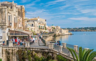 Siracusa waterfront in Ortigia with the castle in background, on a sunny summer day. Sicily, southern Italy. July-15-2018 clipart