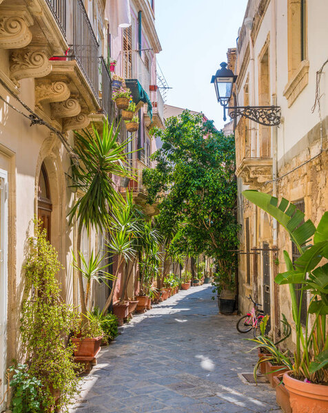 A narrow and picturesque road in Ortigia, Siracusa old town, Sicily, southern Italy.