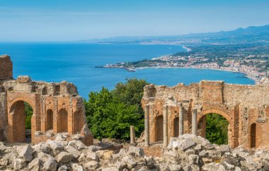 Ruins of the Ancient Greek Theater in Taormina with the sicilian coastline. Province of Messina, Sicily, southern Italy. clipart