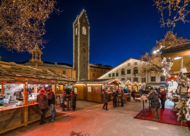The colorful christmas market in Vipiteno in the evening. Trentino Alto Adige, Italy. December-15-2018 clipart