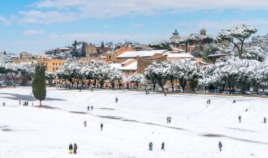 Snow in Rome in February 2018, panoramic view of the Circo Massimo with people playing. clipart