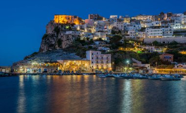 Peschici illuminated in the evening, Foggia Province, Apulia (Puglia), Italy. clipart