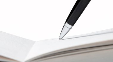 Writing pen in a notebook on white background clipart