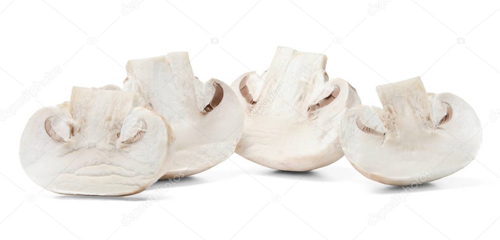 Half sliced champignons on white isolated background. Close-up