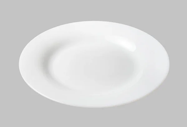 Beyaz tatlı tabağı. Açık gri izole arkaplan. Üst taraf manzarası. Yakın plan..