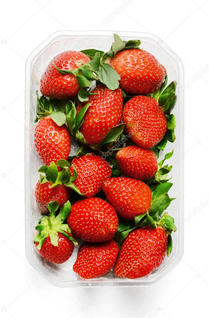 Plastic packaging of fresh juicy strawberries. Saturated colors. White isolated background. Top view.