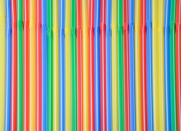 Abstract background of multi-colored tubes for a cocktail located strictly in a straight line. Bright saturated colors.