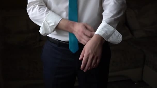 Man Straightens Sleeves White Shirt — Stock Video