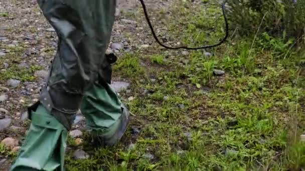 Een militair man in een beschermend pak van straling loopt door het bos in Tsjernobyl met een mijn detector op zoek naar mijnen — Stockvideo