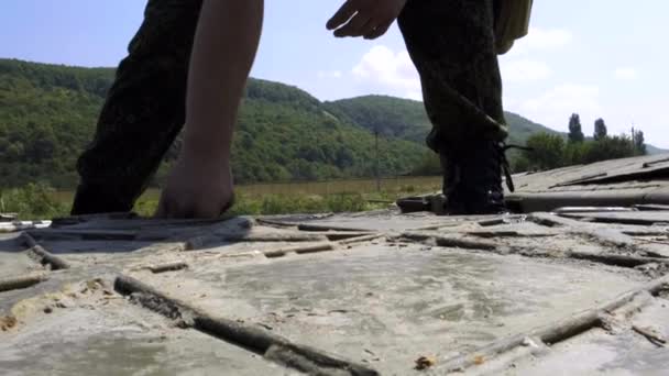 A military cadet soldier works on a pontoon with an internal compartment of a pontoon park based on a KAMAZ truck — Stock Video