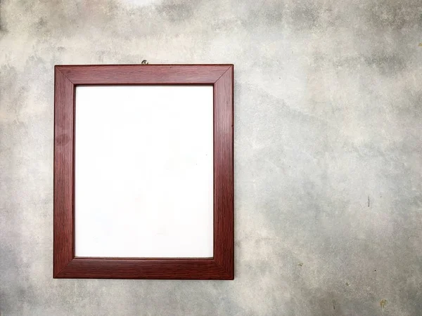 Blank picture frame on concrete wall