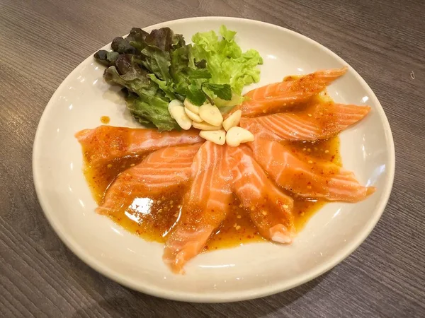 Fresh salmon slices with spicy sauce