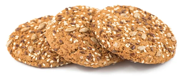 Yulaf ezmeli kurabiye ayçiçeği tohumu, keten tohumu ve susam tohumu ile serpilir. Beyaz bir arka plan üzerinde izole sağlıklı hamur işleri