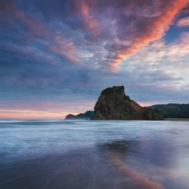 Bulutlu gökyüzü altında dağların ve denizin manzara görünümü