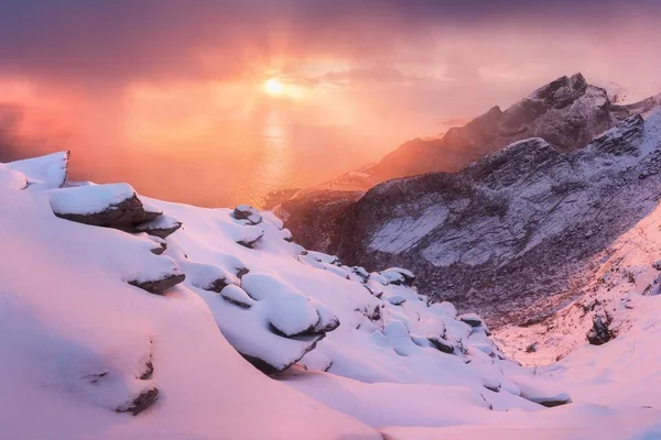 scenic view of mountains in snow at sunset