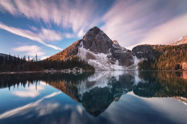 Scenic view of mountains reflecting in water