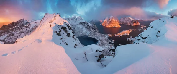 scenic view of mountains in snow at sunset