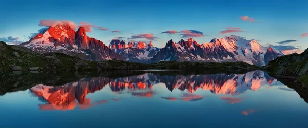 Scenic view of mountains reflecting in water