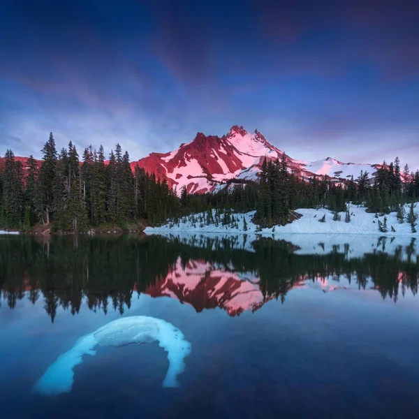 Scenic view of mountains reflecting in water