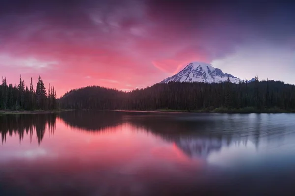 Scenic view of mountains reflecting in water 