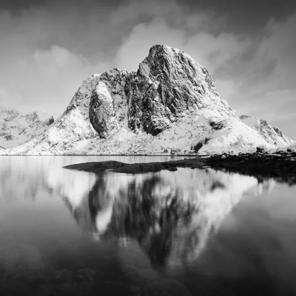 scenic view of lake and mountains in snow, black and white