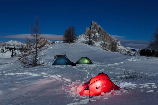 scenic view of tents near mountains in snow