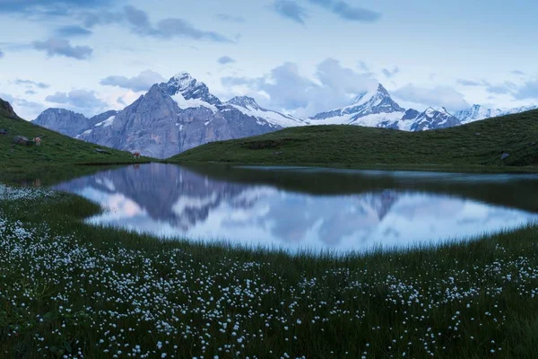 Scenic view of mountains reflecting in water