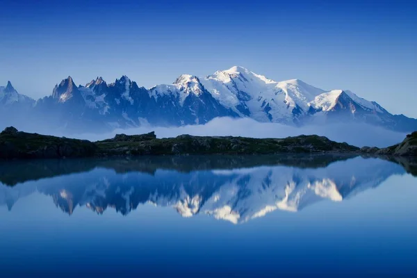 Scenic view of mountains reflecting in water