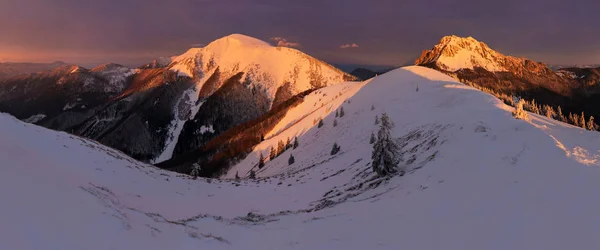 scenic view of mountains in snow at sunset