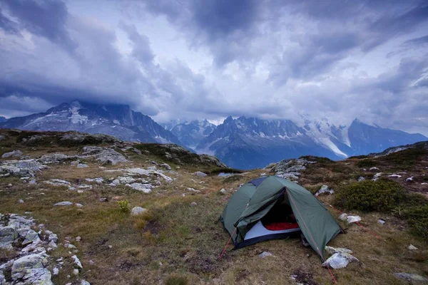 scenic view of tent near mountains at summer