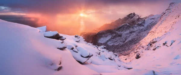 scenic view of mountains in snow at sunset