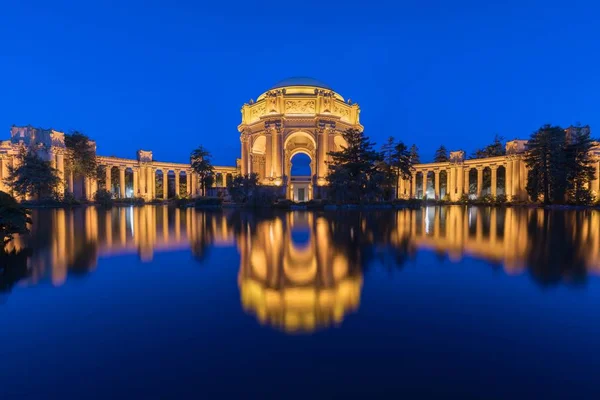 在加州旧金山的夕阳下 金门大桥附近被照亮的美术宫全景 乌萨美丽的历史建筑在池塘中反射 — 图库照片
