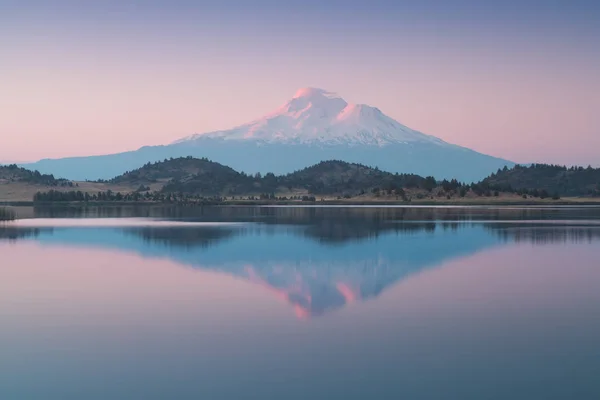 Abd'nin Kaliforniya eyaletinde gün doğumunda göldeki berrak suda shasta dağının karla kaplı bir yansıması. Mount Shasta Siskiyou İlçesi'nde Cascade Aralığı güney ucunda bir yanardağ
