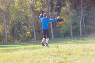 Genç adam parkta spor yapıyor.