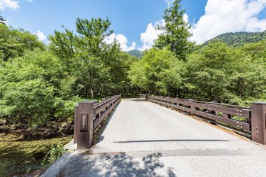 Translation: Bridge named Hotaka at Kamikochi in Japan clipart