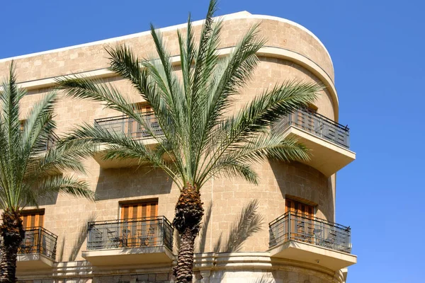 building and palm trees in Jaffa sunny and blue sky