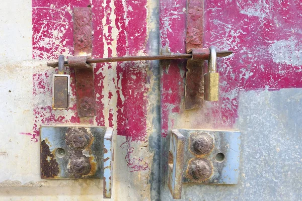 Iron locks on an iron door with large iron loops