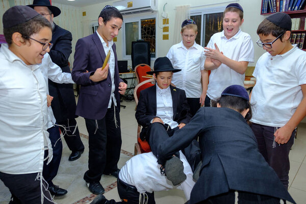 ISRAEL - Netanya, 23 October 2017: Young religious Jews in the synagogue during the bar mitzvah celebration