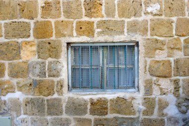 antik kenti ve bir pencere bir kafes ile antik taş duvar dokusu