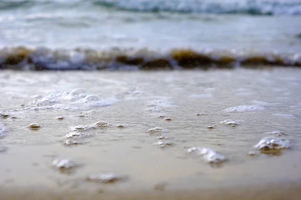 sea foam and sand and sea bubbles on the Mediterranean Sea in Israel