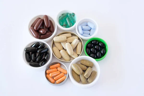 vitamins pills medications biological supplements pills multicolored round oval lie in a chaotic order on a white background