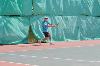 İsrail - Netanya, 27 Temmuz 2018: genç bir adam bir spor gömlek ve spor şort tenis kortunda tenis oynuyor